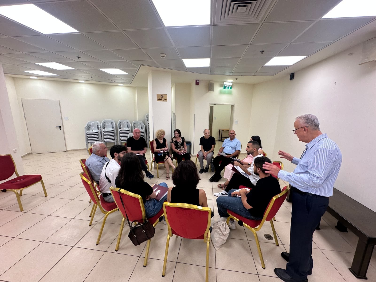 Participants of the Arab Civic Council founding assembly seated in a circle for a working-group discussion, Haifa, 1 July 2026.
